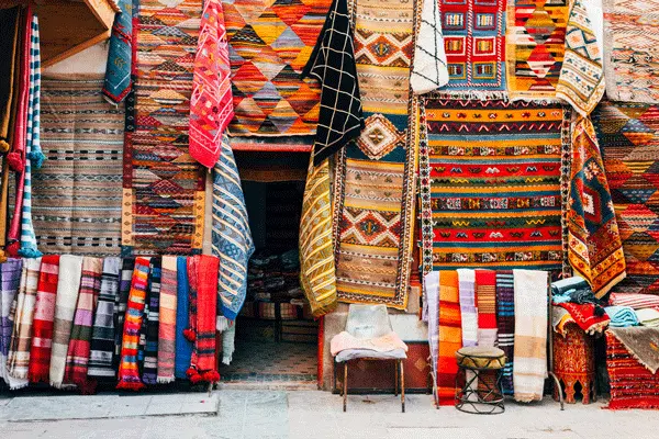 A colorful display of spices and lanterns in a Marrakech souk.